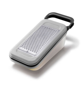 Stainless steel grater with sealed container
